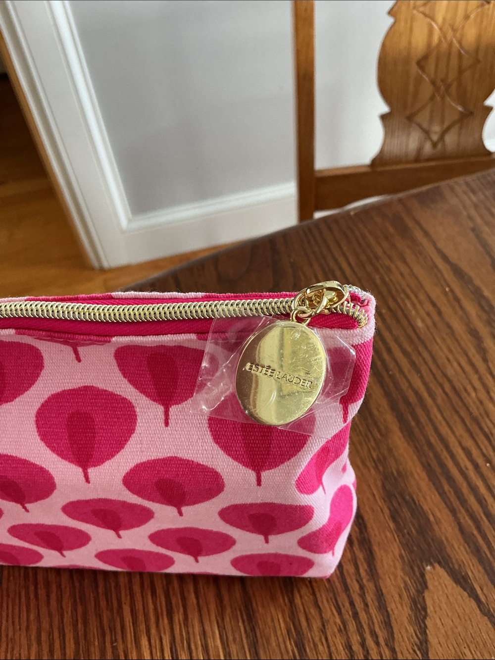 Estée Lauder "Beauty in Bloom" makeup bag featuring a pink and white leaf patter